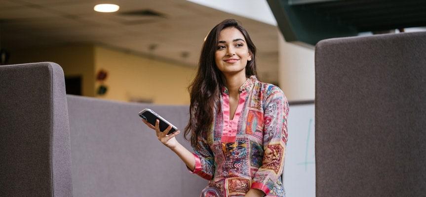 a picture showing a girl with a smartphone surfing social networks